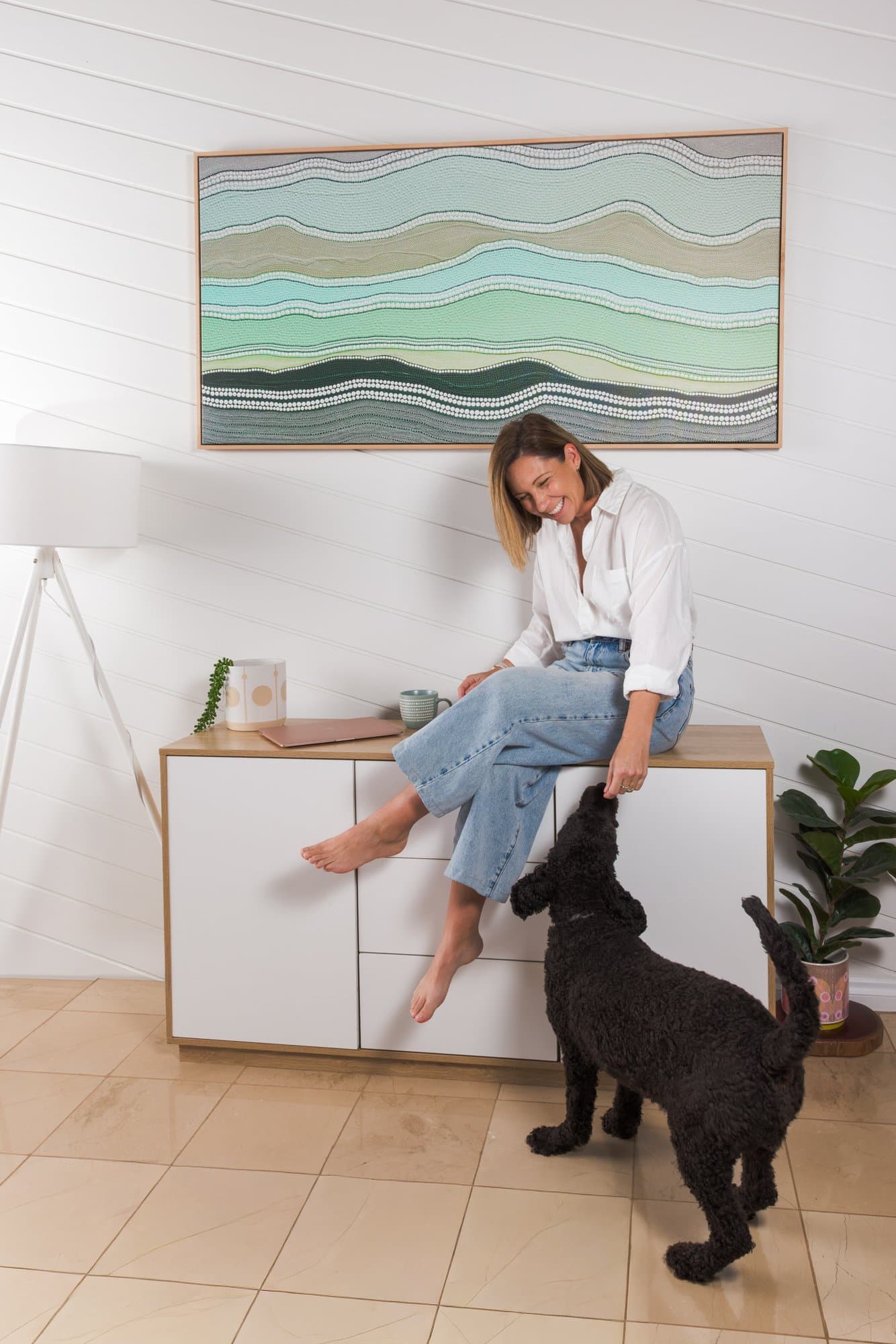 Steph laughing with her dog, who is up on hind legs beside her